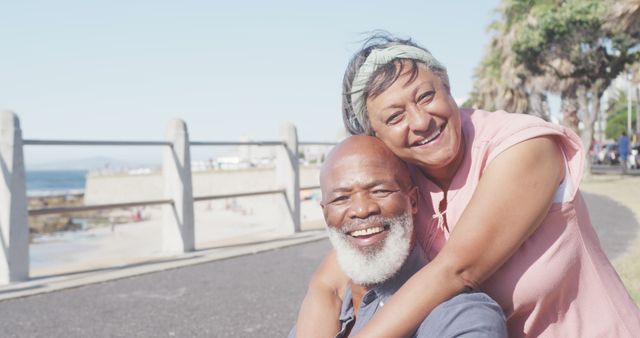 Smiling Couple Hugging on Beachfront Walkway - Download Free Stock Images Pikwizard.com