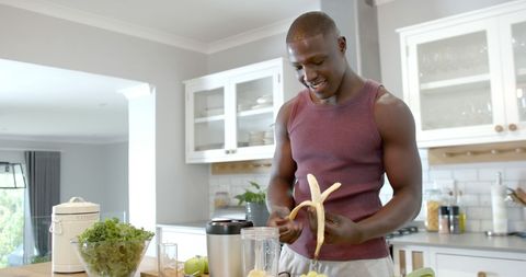 Man Preparing Healthy Smoothie at Home in Modern Kitchen