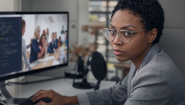 Professional woman hosting remote meeting in office setting