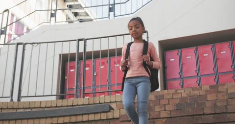 Confident Girl Descending School Steps with Backpack