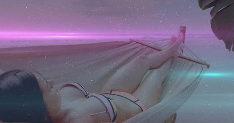 Woman Relaxing in Hammock on Tropical Beach at Sunset with Lens Flare Effect