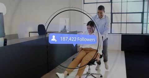 Pushing colleague on swivel chair while celebrating social media follower growth overlay