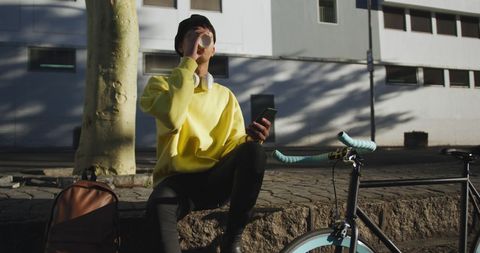 Man Relaxing with Coffee and Smartphone on Urban Street - Download Free Stock Images Pikwizard.com