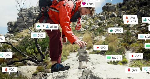 Hiker stacking cairn on rocky ridge with social icons overlay for outdoor adventure