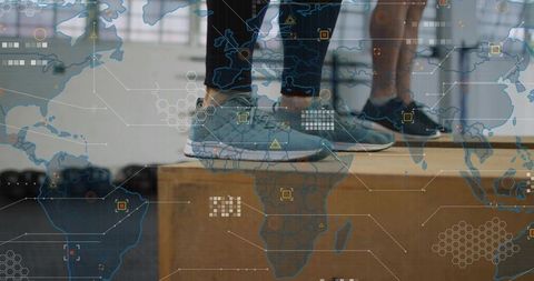 Partners standing on plyometric box wearing trainers with global tech overlay