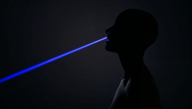 Silhouette emitting blue beam from mouth, futuristic minimalist profile with dramatic light