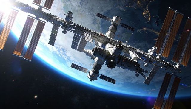 Orbiting Modular Space Station Showcasing Solar Arrays Docking Ports and Planetary Terminator