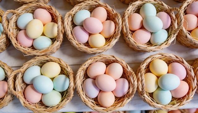 Displaying pastel easter eggs in wicker baskets grid pattern for spring decor