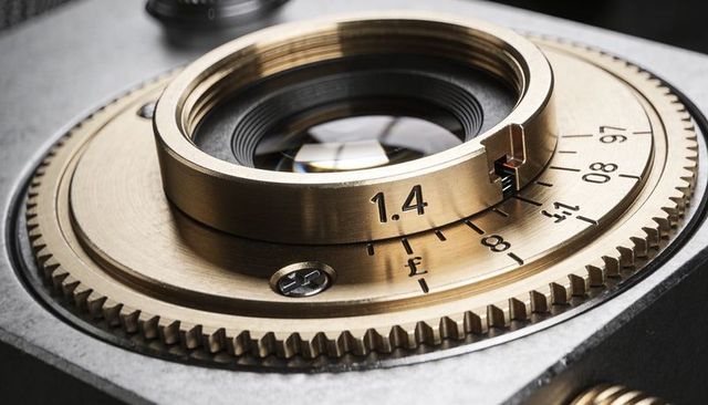 Brass camera aperture ring featuring engraved 1.4 marking macro closeup detail