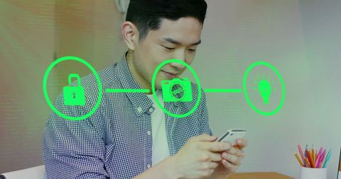 Asian Businessman Utilizing Smartphone with Digital Icons