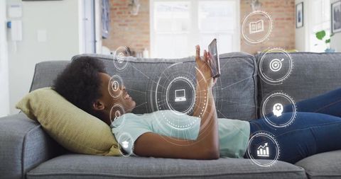 Teen Girl Enjoying Digital Content with Virtual Interface on Couch