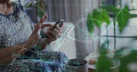 Senior woman tapping smartphone and scrolling with holographic dna data overlay at home