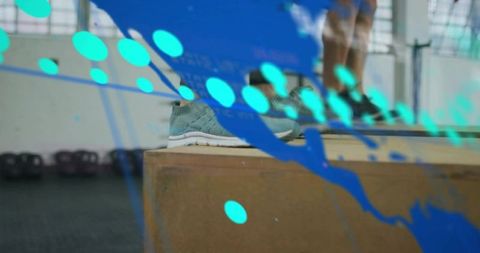 Female athlete resting blue sneaker on plyo box with teal motion overlay for fitness promo