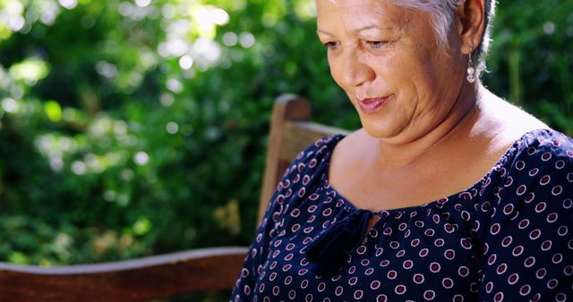 Elderly woman smiling peacefully while enjoying time in garden. Perfect for illustrating concepts related to senior lifestyle, relaxation, and spending time in nature. Can be used in promotional material for retirement communities, wellness programs for seniors, and lifestyle blogs.