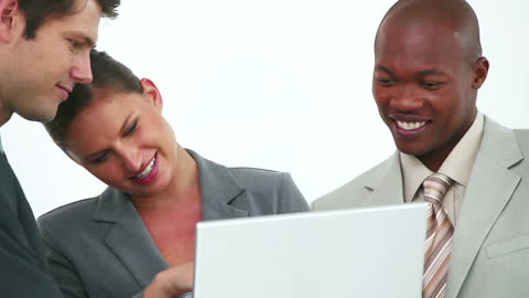 Diverse Business Team Collaborating on Laptop