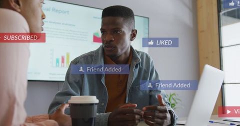 Discussing social media engagement and analytics in modern office meeting with laptop