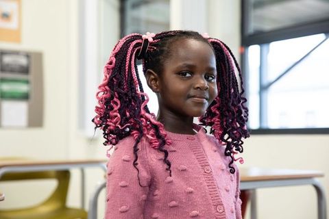 Confident Young Girl in Classroom Enhancing Education Theme