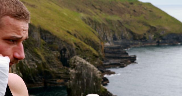 Tired Man with Rocky Cliffside Coastal Background - Download Free Stock Images Pikwizard.com