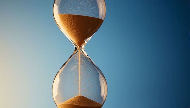 Hourglass with Golden Sand Flowing Through Glass Neck on Blue Gradient Background