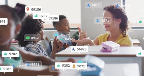 Schoolchildren engaging with digital media icons in classroom
