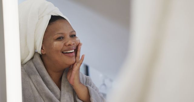 Smiling Woman in Robe Applying Skincare Product - Download Free Stock Images Pikwizard.com