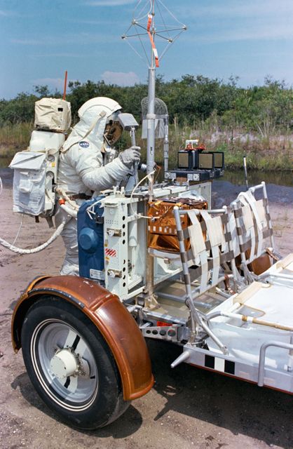 S72-48890 (September 1972) --- Scientist-astronaut Harrison H. Schmitt, lunar module pilot of the Apollo 17 lunar landing mission, procures a geological hand tool from the tool carrier at the aft end of the Lunar Roving Vehicle during lunar surface extravehicular activity simulation training at the Kennedy Space Center (KSC), Florida. Schmitt grasps a scoop with extension handle in his right hand.