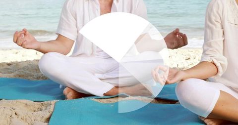 Couple meditating on sandy beach with circular graphic overlay for wellness branding