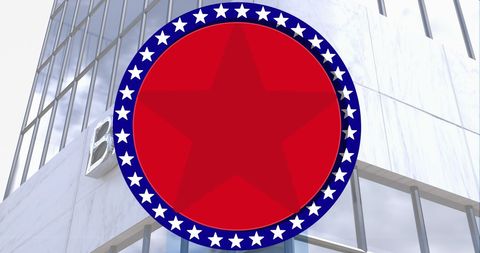 Circular star emblem over modern glass building facade