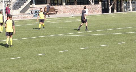 Soccer Players Practicing and Dribbling on Field During Sunny Day