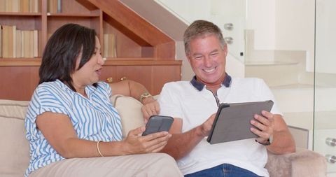 Senior Couple Engaging with Technology in Modern Living Room