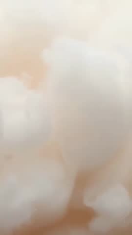 Panning vertical macro video revealing soft cotton-like tufts on warm beige backing