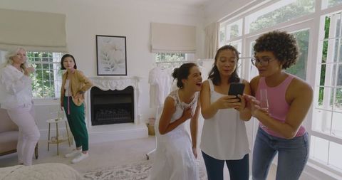Joyful Bride and Friends in Bridal Suite Preparing for Wedding