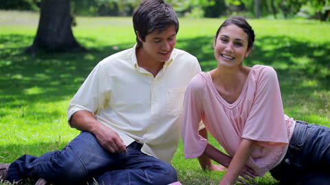 Happy Couple Relaxing Together in Green Park Setting