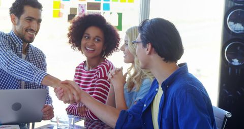 Diverse Professionals Engaged in Handshake During Successful Meeting
