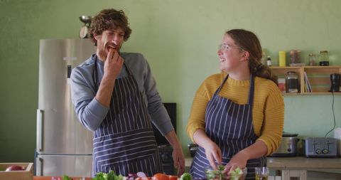 Joyful Couple Bonding Over Cooking in Rustic Kitchen