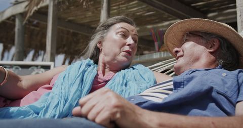 Senior Couple Relaxing in Hammock by Beach