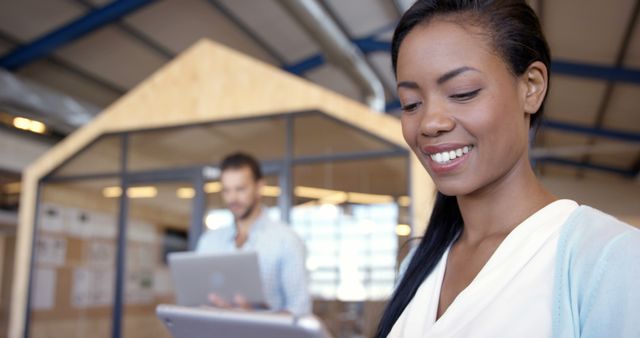 Smiling African American Woman Working in Modern Office Environment - Download Free Stock Images Pikwizard.com