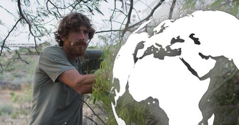 Bearded hiker reaching through branches on semiarid hillside with stylized globe overlay