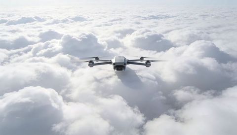 High-altitude drone flying over cloudscape with camera and four rotors capturing horizon