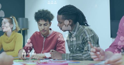 Diverse colleagues collaborating on creative project with social network overlay