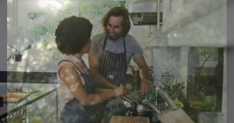 Couple Preparing Meal Together in Home Kitchen