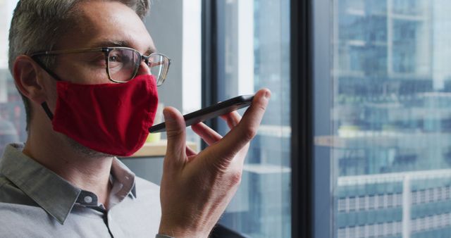 Businessman Wearing Red Mask Using Voice Assistant on Smartphone - Download Free Stock Images Pikwizard.com