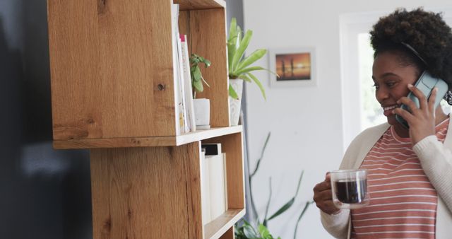 Smiling Woman Talking on Phone While Drinking Coffee at Home - Download Free Stock Images Pikwizard.com