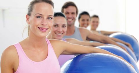 Fitness Class Holding Exercise Balls and Smiling at Camera - Download Free Stock Images Pikwizard.com