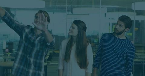 Team collaborating behind office glass partition