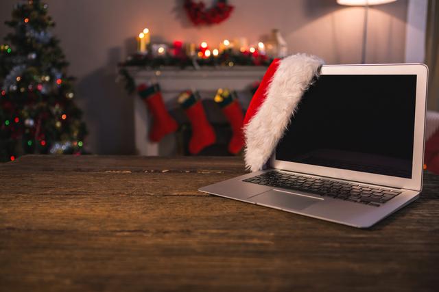 Santa hat hanging on laptop at home