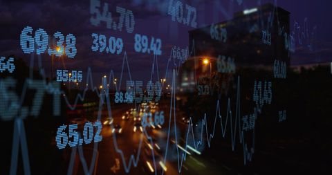 Financial Data Overlaying Cityscape At Dusk