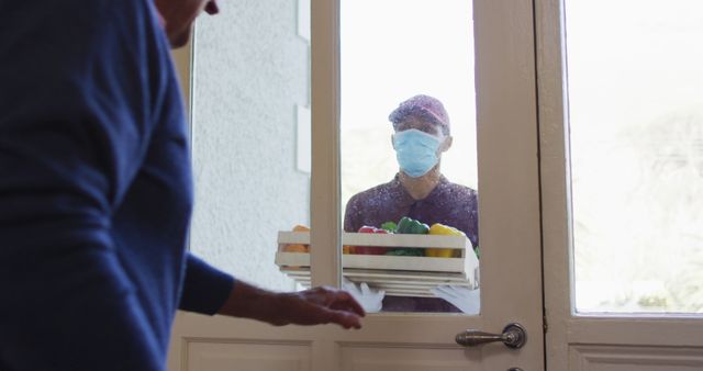 Masked Delivery Person Handing Groceries to Older Adult at Door - Download Free Stock Images Pikwizard.com