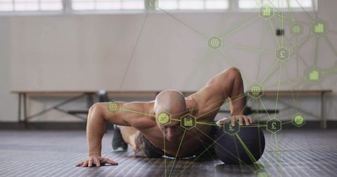 Bald Athlete Performing One-Arm Medicine Ball Push-Up Showing Strength, Balance and Focus
