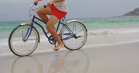 Barefoot Cycling Along Sunny Beachfront Shoreline - Download Free Stock Images Pikwizard.com